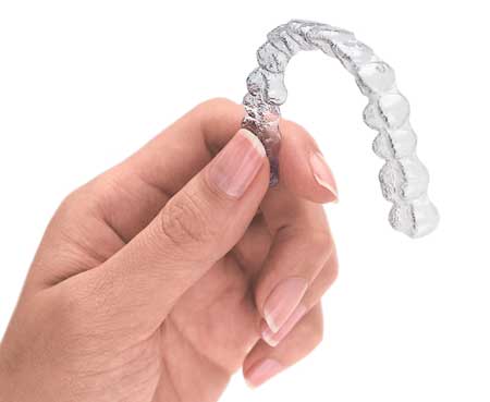 Invisalign aligner in hand Elite Orthodontics Group in San Diego, CA